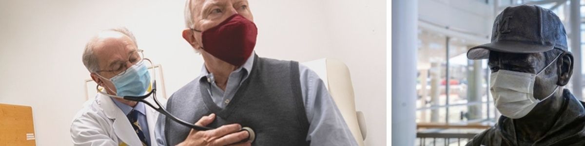 Doctor Kim Eagle wearing mask using stethoscope on older male patient wearing mask