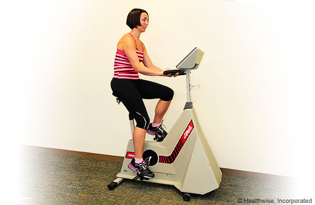 A woman exercising on a stationary bike
